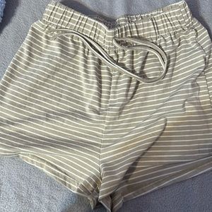 Light brown kind of light greenish shorts with white stripes